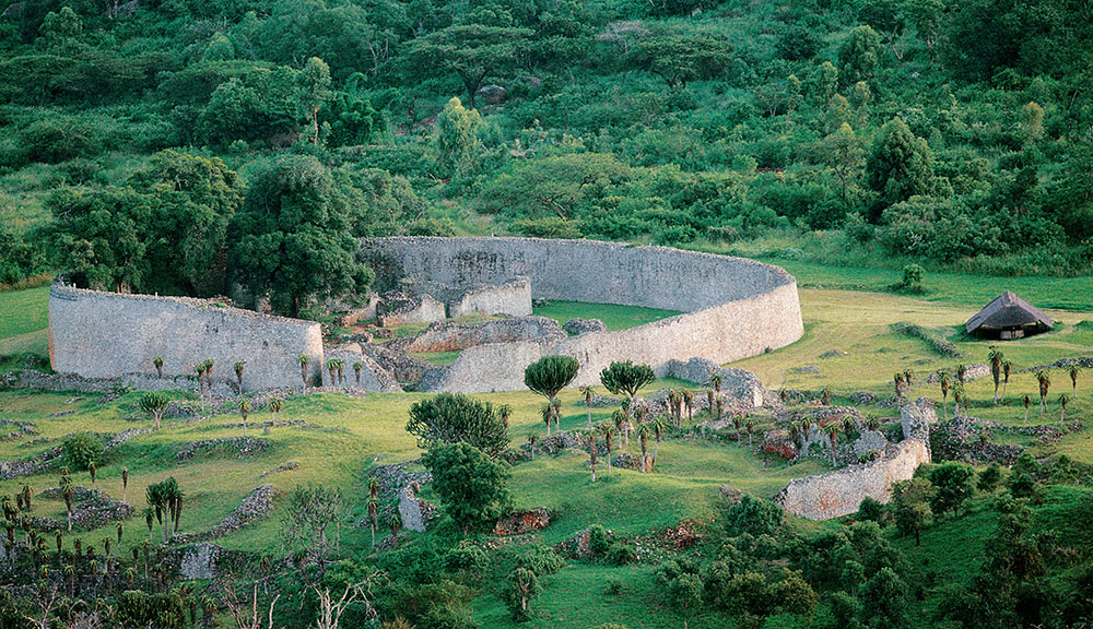 The ruins of Great Zimbabwe in a grassy area.