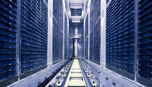 Photograph of huge, long hallway with many drawers on the sides and tracks along the middle.