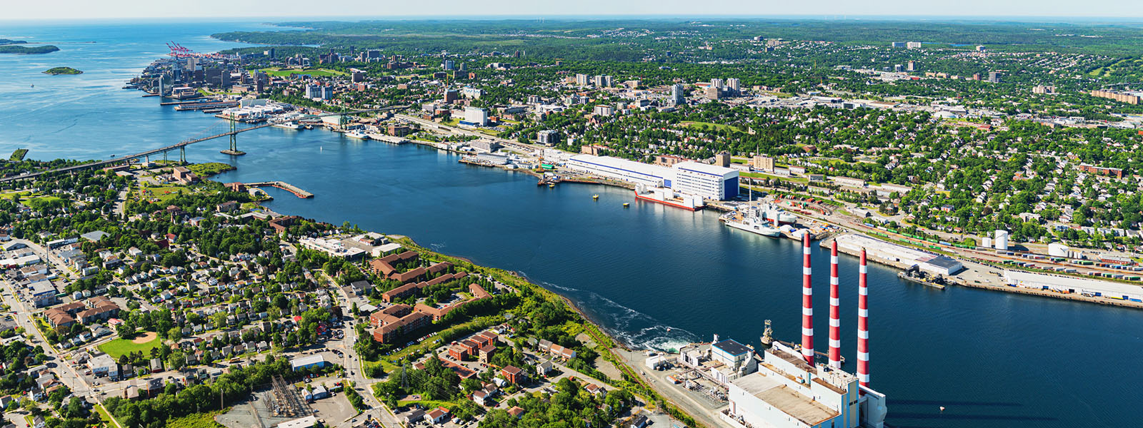 Halifax harbor with smokestacks of a power plant in foreground.