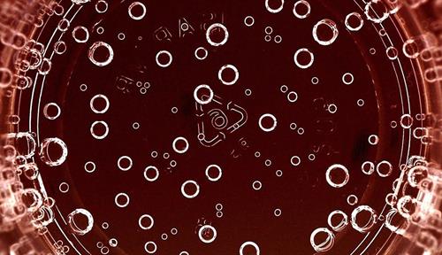 Bubbles at the bottom of a glass, viewed from above.